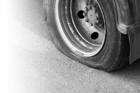 Blown away a dirty rusty car wheel truck. There are signs of deliberate damage to the wheel.の写真素材