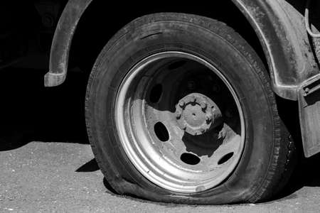 Blown away a dirty rusty car wheel truck. There are signs of deliberate damage to the wheel.の写真素材