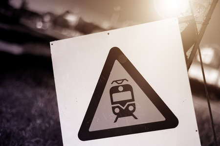 Abandoned road sign of a railway crossing on the background of grass. The background is blurred.の写真素材
