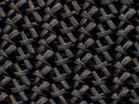 Close-up of synthetic fabric, black fiber. There is a large gap between the fibers, neatly woven,...