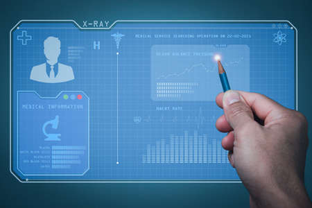 A man  holds a pencil with his right hand, with his power pointing to a 3D monitor that displays health information. Blood test results, blood pressure Heart rateの写真素材