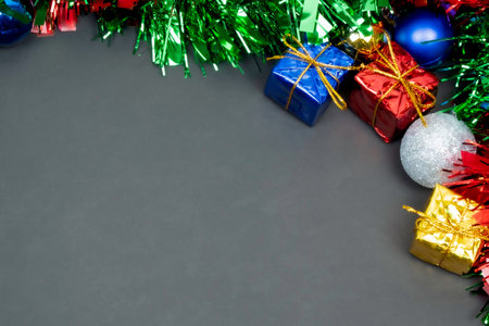 Christmas border template with fir branches, Beautiful red green blue, and gold toys and ribbon, on...