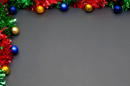 Christmas border template with fir branches, Beautiful red green blue and gold toys and ribbon,on...