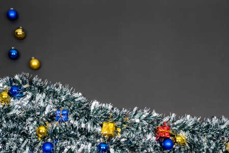 Christmas border template with fir branches, Beautiful red green blue and gold toys and ribbon,on space gray color background, Merry Christmas and Happy New Year.の写真素材