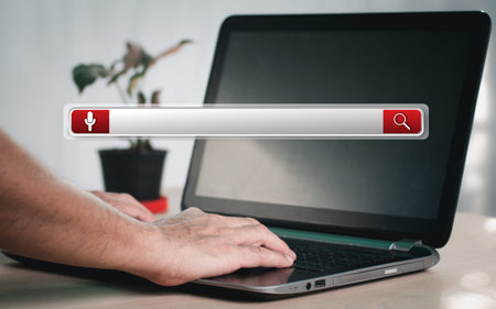 Man's hands are using a computer keyboard to Searching for information data. The concept is...