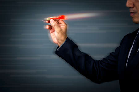 businessman throws darts with speed and force to hit the target accurately and quickly. The concept is to succeed in business administration.の写真素材