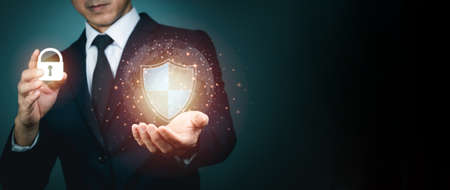 Businessman holding shield protect icon for internet firewall, insurance, or computer virus cleaner. Concept cyber security safe your data.の写真素材