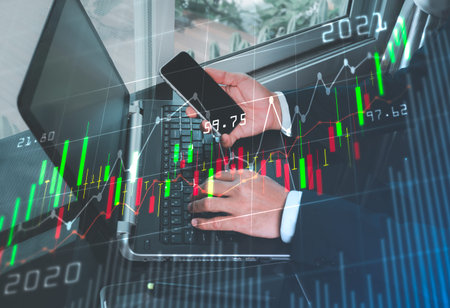 A man in a suit holds a mobile phone with his right hand.  The side area has a stock graph that is...