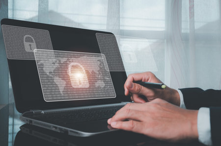 The concept is Cyber Security, digital data protection, and Business working on laptops at the...