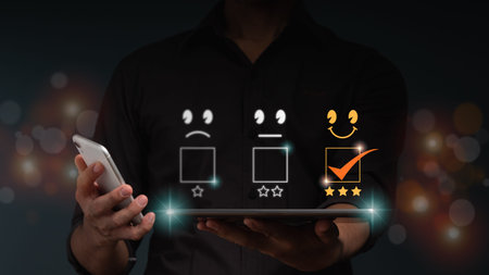 The businessman hold a tablet computer with smile and 3 stars icon for customer services best...
