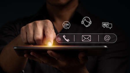 A man points to an operator's symbol, with icons for after-sales services. Communication channel of customer satisfaction.の写真素材