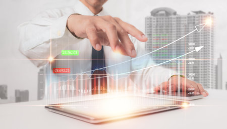 Interface goal chart, a businessman uses a tablet to analyze growth graph financial data and sales...