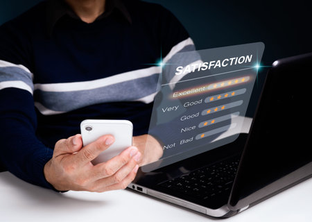 A man uses his smartphone to select a 5 star emoticon to display on the virtual screen. A survey,...