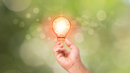A light bulb in one's palm, a notion of inspiration from internet technology, an innovation idea...
