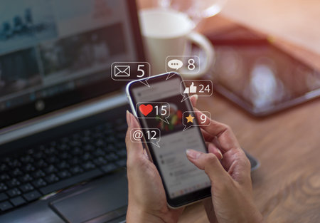 a woman typing on her smartphone to interact with others via emoji and text online Above the...