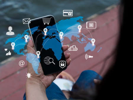 The lady sends digital marketing, social media commercials, e-commerce, online purchasing, and IoT (Internet of Things) concepts by cell phone.の写真素材