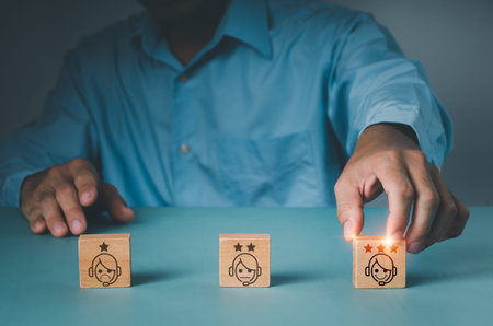 A guy picks a face grin emoticon with his finger to put on a wood block. A survey, poll, or...