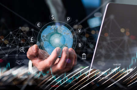 Concept; business analysis, strategy and planning, finance analyst working on laptop computer, business data and economic growth, financial graph chart, stock market report, coins stack in foreground.の写真素材