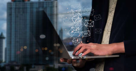 A businessman motions to an operator sign, which contains symbols for after-sales services. Communication route for customer satisfactionの写真素材