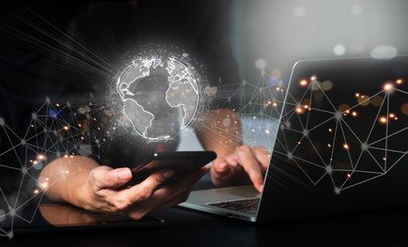 A businesswoman is utilizing her cell phone to connect to a global network for digital marketing. Financial, banking, investment, global business, data sharing, business development.の写真素材