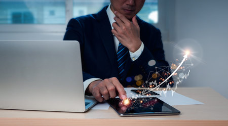 A businessman or trader displays expanding virtual holographic stocks and invests in trading. Idea...