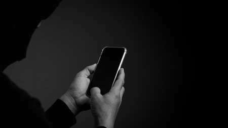 cybercrime committed by unauthorized users.He uses a mobile device to access a target's website.の写真素材