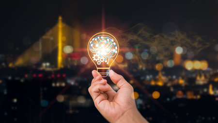 A businessman holds a virtual lightbulb in one hand and his brain on the other to show how his concept works. clever idea and creative inspiration.の写真素材