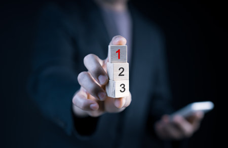 The concept of priority tasks and management. the hierarchy of any given task. Prioritize your job and make a to-do list. First, second, and third-numbered wooden cubes.の写真素材