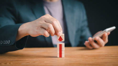 A business strategy and action plan are used to personally arrange wood blocks while focusing on the business concept. strategies for creating an organizationの写真素材