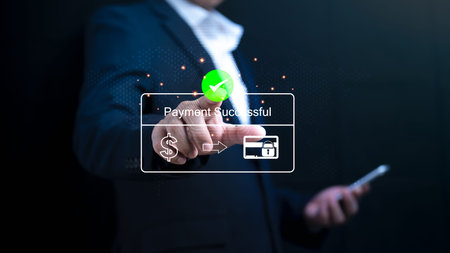 A businessman uses a mobile phone scanner to shop, bank, and make online payments.  Applications for...