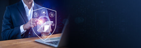 Businessman interacting with AI cyber security shield interface on laptop, protecting digital data and secure network, data encryption and cyber defense technology.の写真素材