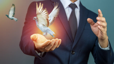 The concept of business freedom and vision. A hand releases a digital pigeon, signifying the launch of a new project, strategic growth, and the pursuit of peace and opportunity.の写真素材