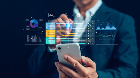 Businessman using smartphone with futuristic AI analytics dashboard, data visualization, and digital...