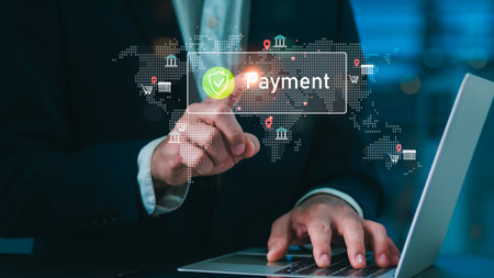 Businessman using laptop and touching virtual payment icon with secure digital finance interface, representing online banking, fintech, e-commerce, and global financial technology innovation.の写真素材