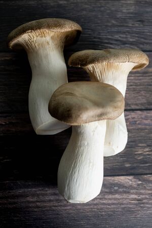group of mushrooms Pleurotus eryngii on wooden table.の写真素材