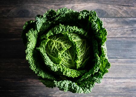 Plan view of savoy cabbage on wooden tableの写真素材
