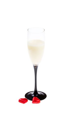 Glass with liquor and two red hearts (isolated)の写真素材