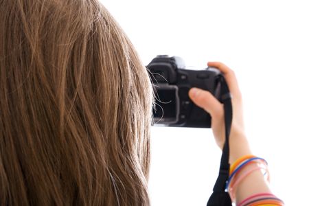 The young beautiful girl with the camera isolated on a white backgroundの写真素材
