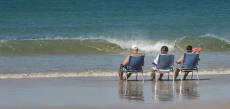 Seniors by the sea relaxing in the summerの写真素材