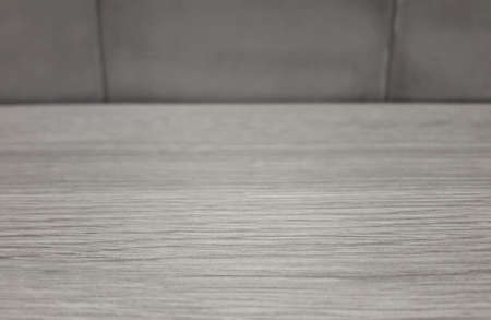 Wooden table with tiles in the backgroundの写真素材