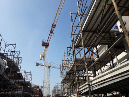 Work in progress on the construction site - crane and scaffoldingの写真素材