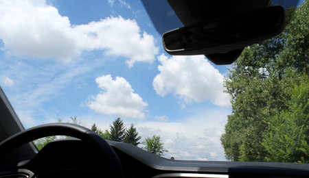 Traveling by car in the summer in the countryside - tourist or commuter