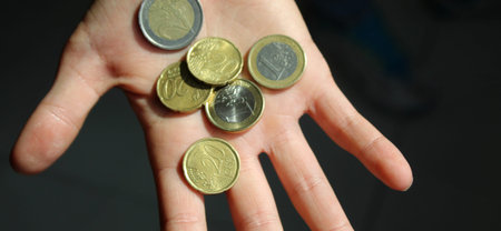 Euro coins in the hands of a boy
