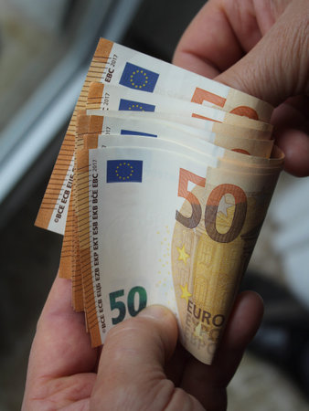 Euro banknotes in the hands of a person - wealth