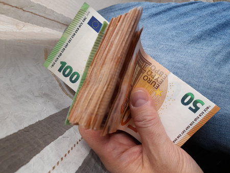 Euro banknotes in the hands of a rich person