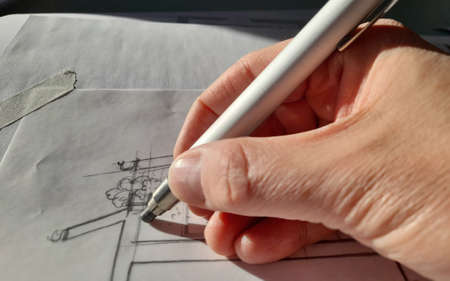 Architect designing freehand in his officeの写真素材