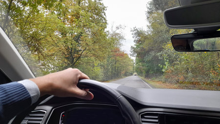 Driving the car in the countryside on a cloudy autumn day