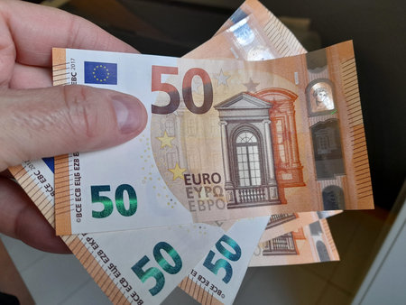 Banknotes of 50 euros in the hands of a wealthy man