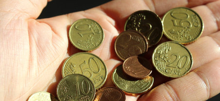 Euro coins in the hands of a man