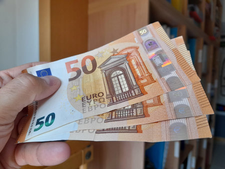 Banknotes of 50 euros in the hands of a man - wealth